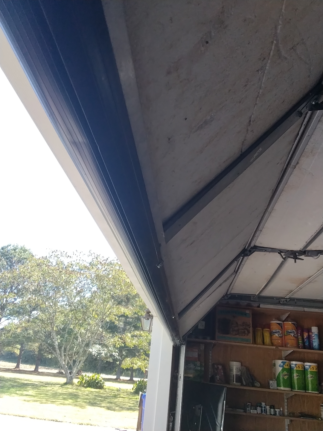 Fresh EPDM bulb seal seated in a clean retainer on a Hampton Roads garage door, the bottom seal that stops rodents and air leaks