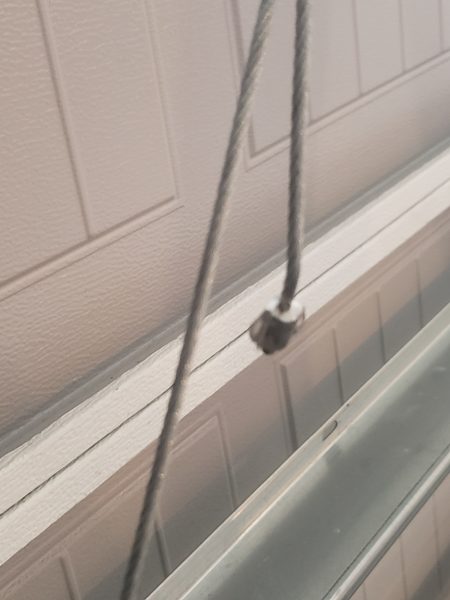 Garage door cable and drum close-up