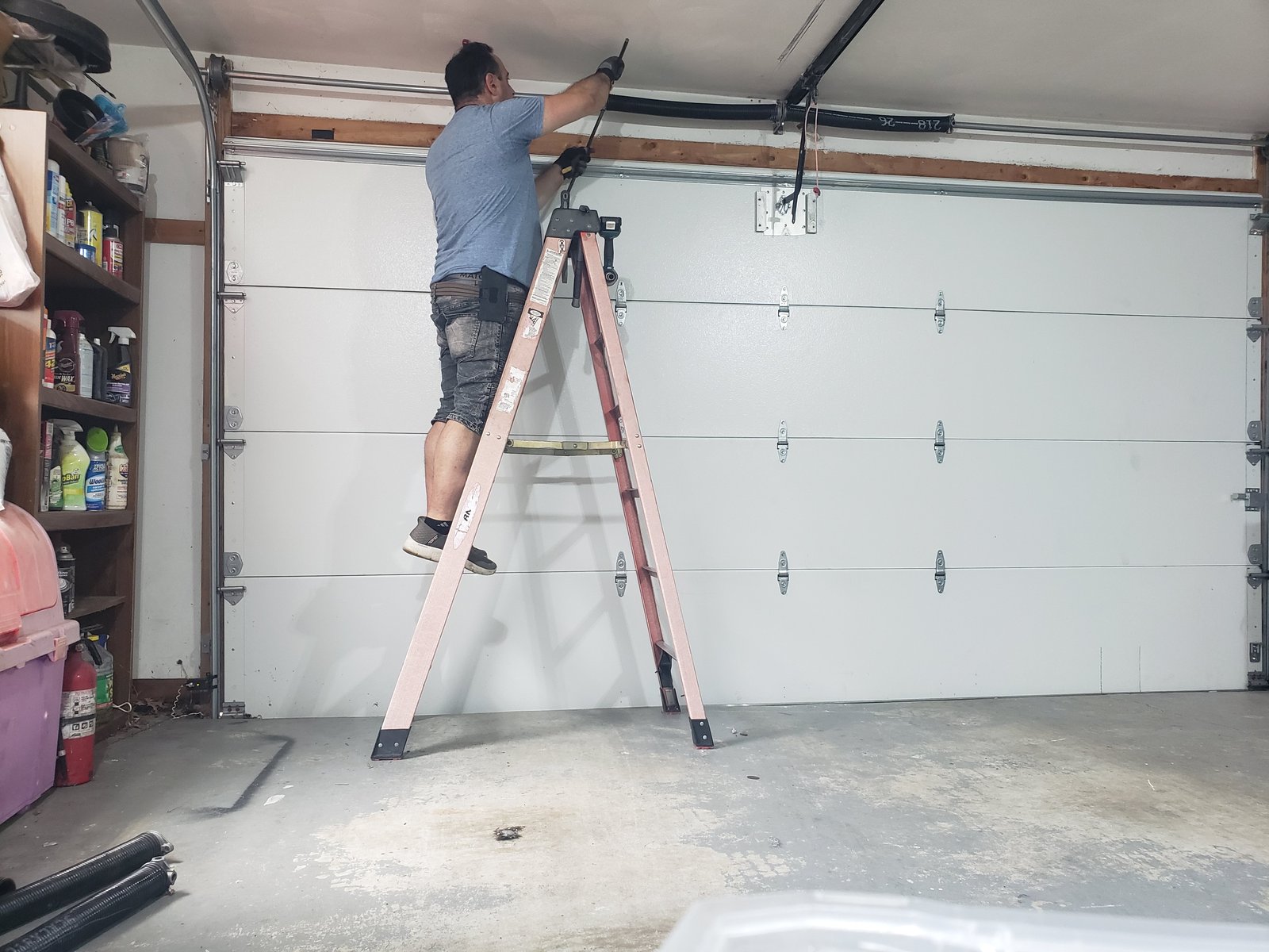 Inside view of a wind-rated garage door showing reinforced torsion hardware and heavy-gauge struts