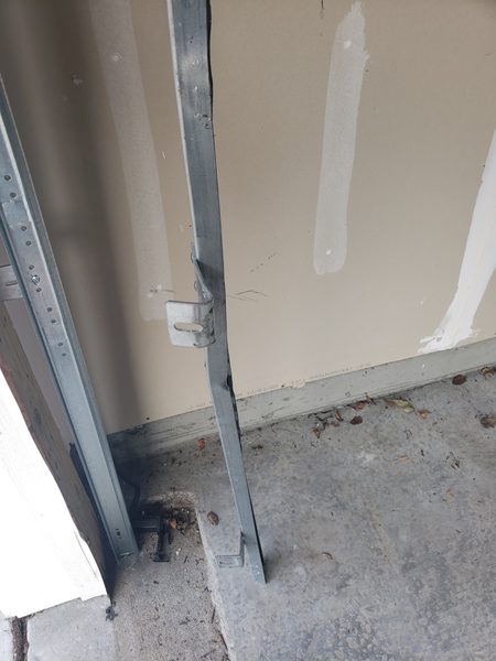 Bent garage door track being replaced
